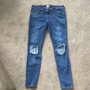 Buckle Sneak Peek jeans with knee rips